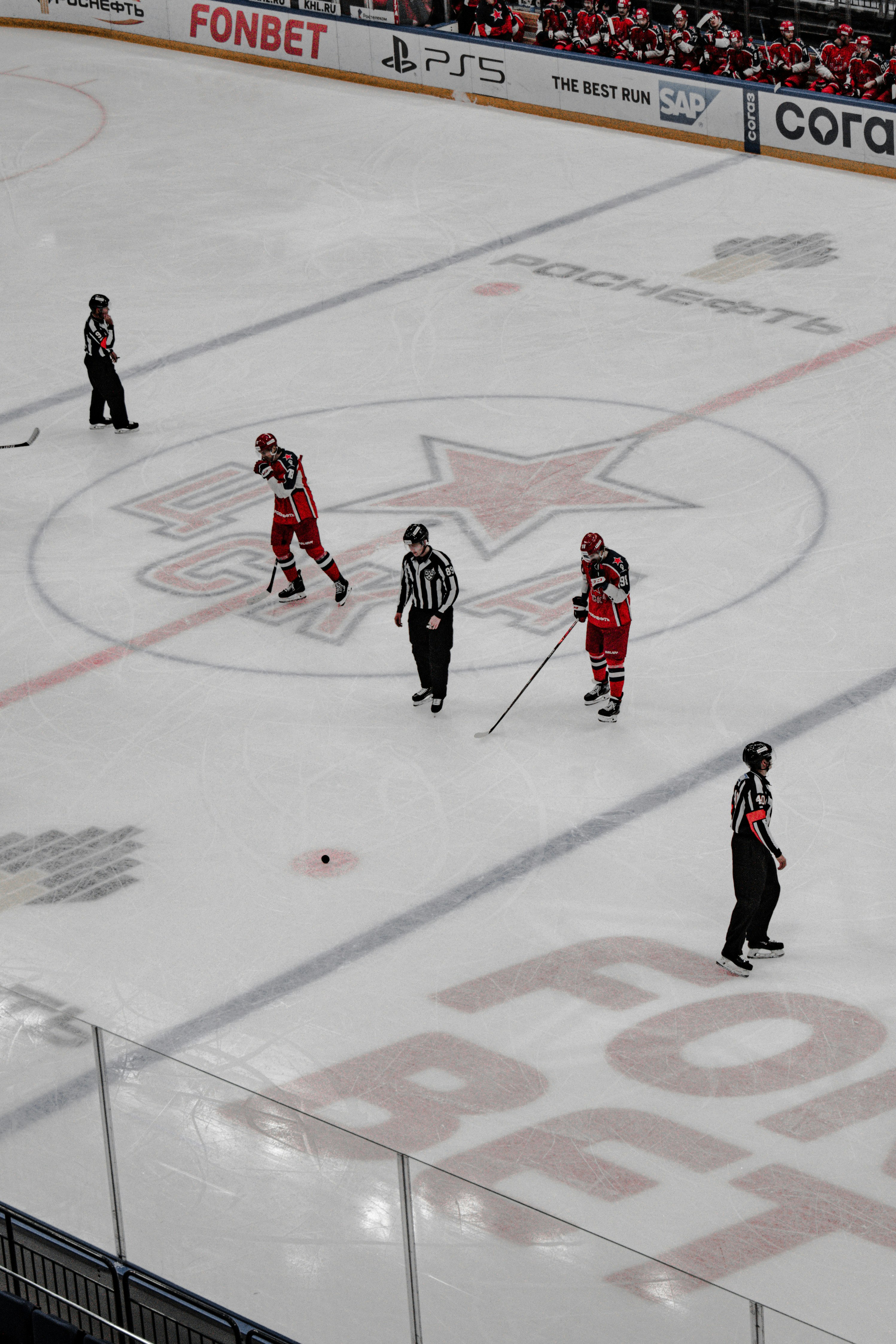 people playing ice hockey on ice field